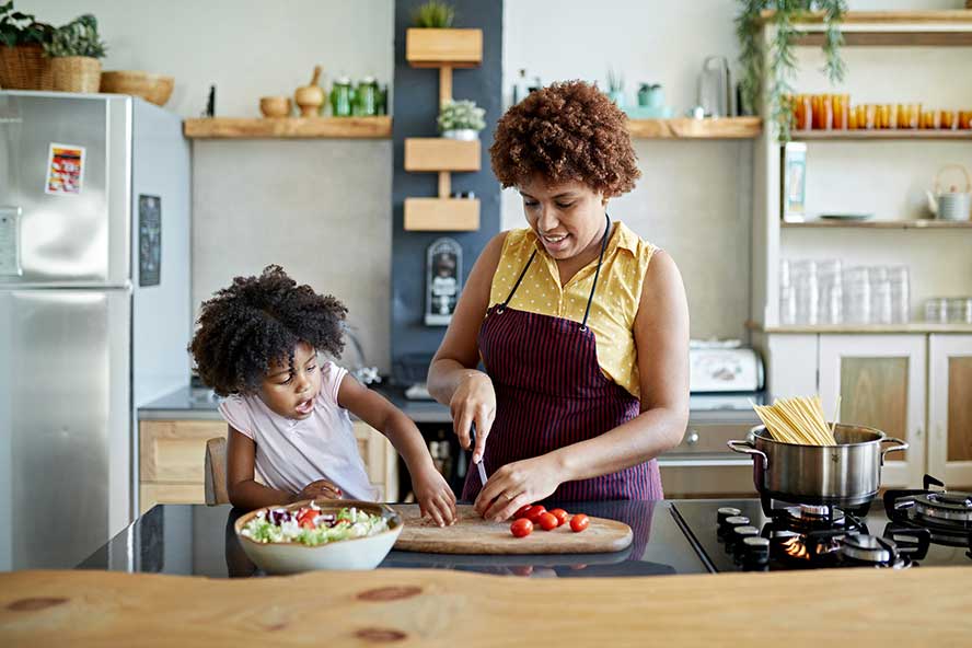 Woman and child cooking in a kitchen